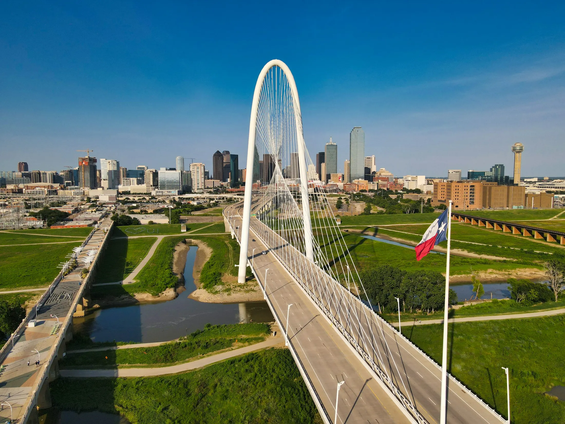 The Margaret Hunt Hill Bridge with the Dallas skyline behind it
