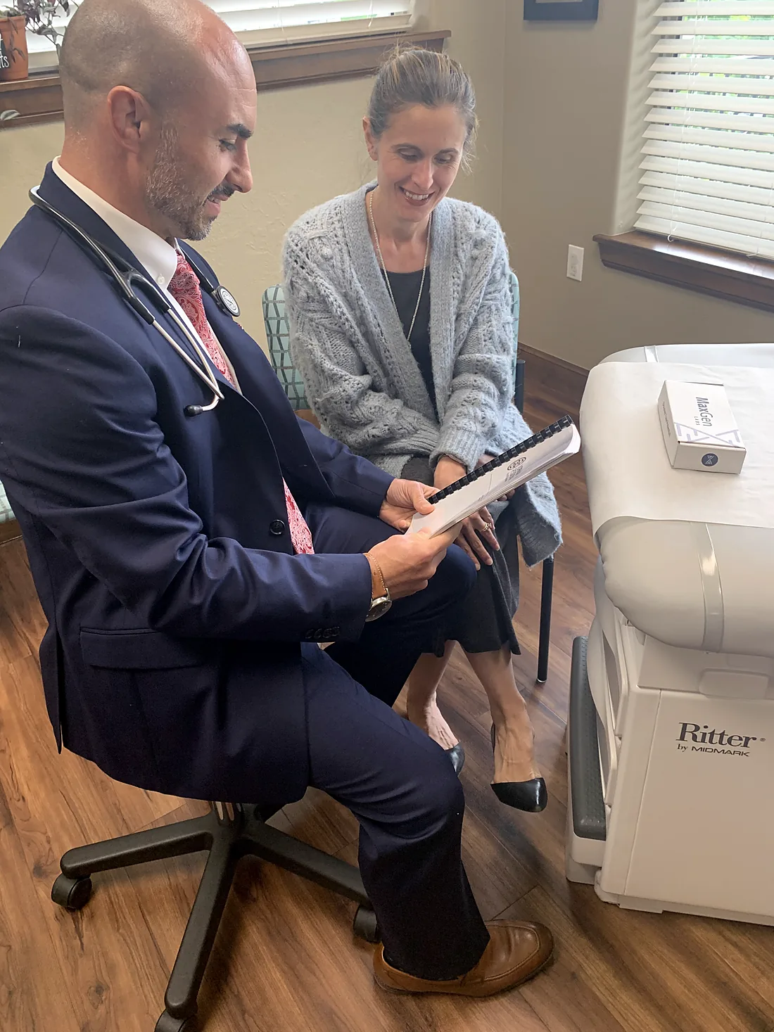 Dr. Cas reviewing results on a tablet with a patient